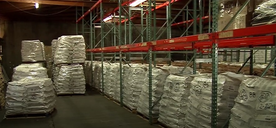 A warehouse full of large bags of black beans.