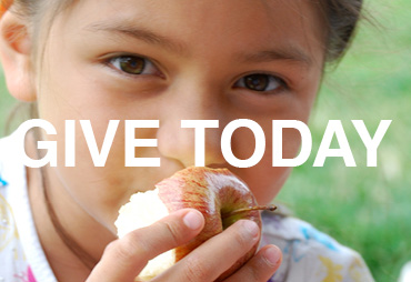give today young person eating an apple smiling into camera