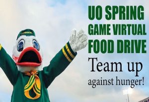 uo spring game virtual food drive team up againts hunger uo duck raises his arms against blue sky