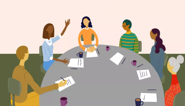 cartoon - several people sit around a circular table with papers; one person is raising a hand