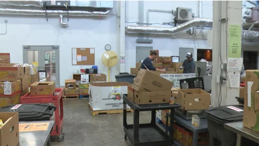 Volunteers at FOOD For Lane County's warehouse sort through donated food items and stuff them in boxes that will be ready to ship out to local meal sites. 